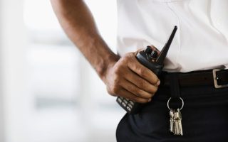 A man working for a man guarding company, helping to keep a site safe and secure.